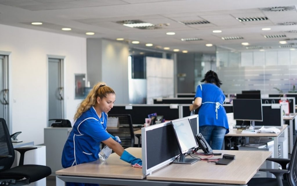 Office cleaning with DNA Cleaning Solution in a modern workspace.