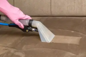Professional sofa cleaning using DNA Cleaning Solution with steam cleaning equipment.