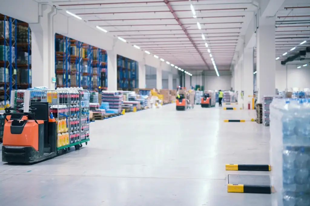 Forklifts handling goods in a warehouse storage area